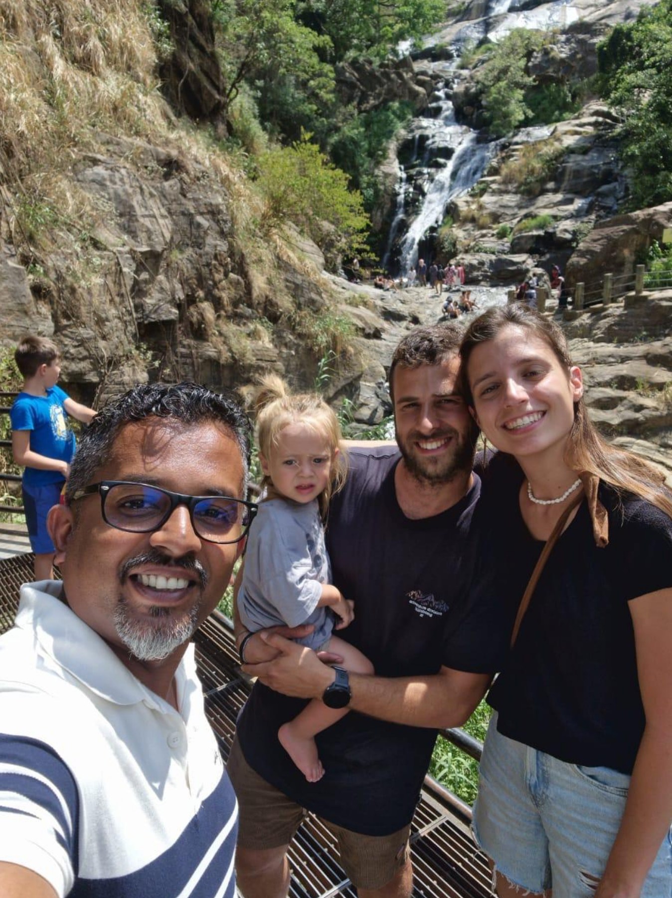 Family travellers with their driver at a Sri Lanka waterfall