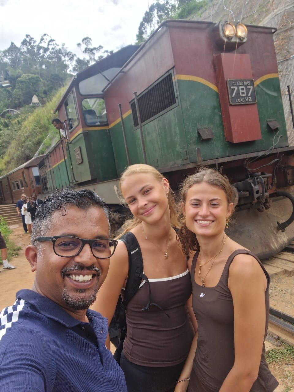 Travellers with driver beside the Kandy to Ella train