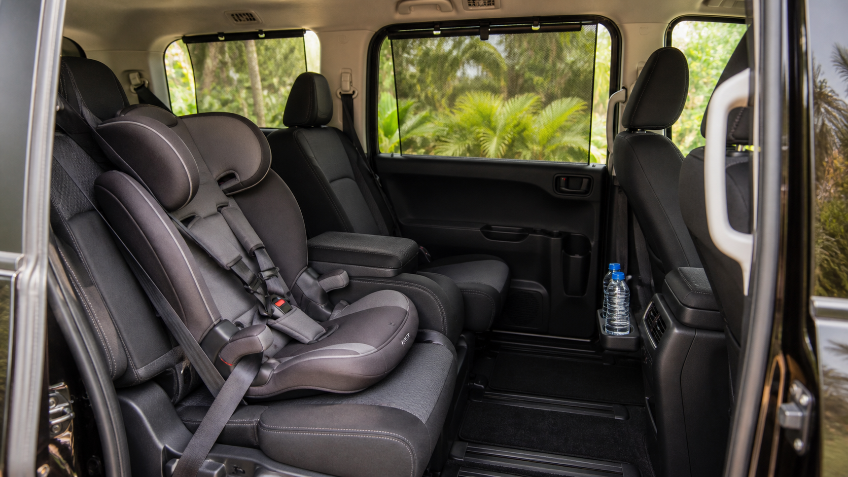 Family-friendly minivan interior with a child seat, seat belts and rear air-conditioning