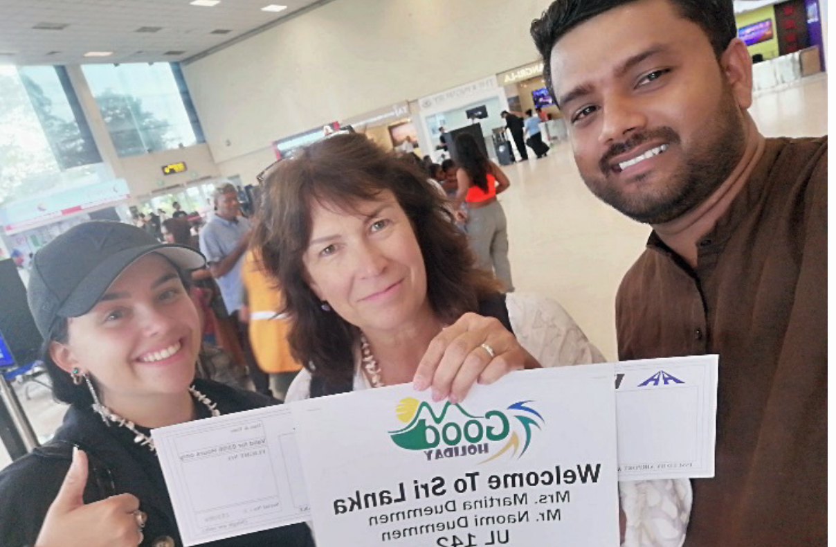 Travellers meeting their private driver with a name board at Bandaranaike airport