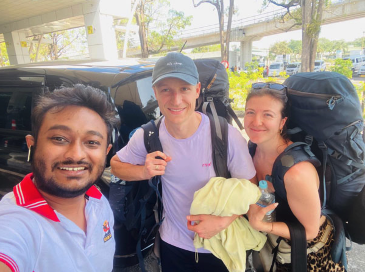 Backpacking travellers meeting their private taxi-charter driver in Sri Lanka