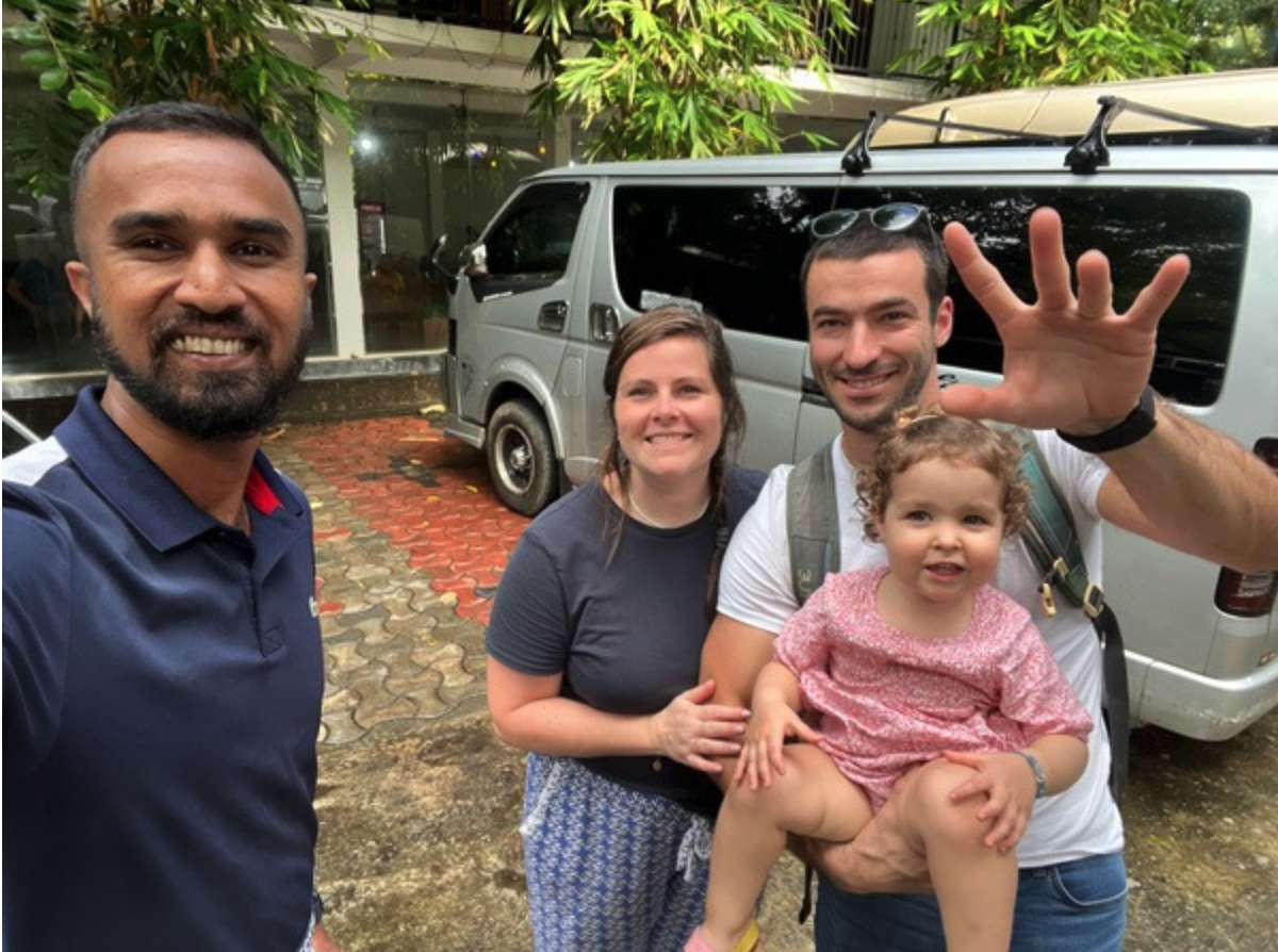 Family and private taxi-charter driver beside a minivan in Sri Lanka